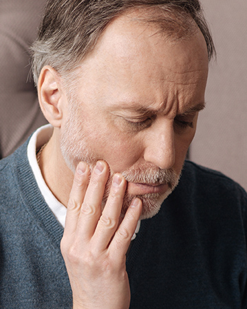 man experiencing tooth pain